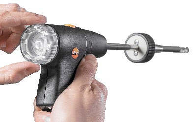 Hands holding the modular flue gas probe for a Next-Gen testo 300 at its transparent particle-filter chamber.